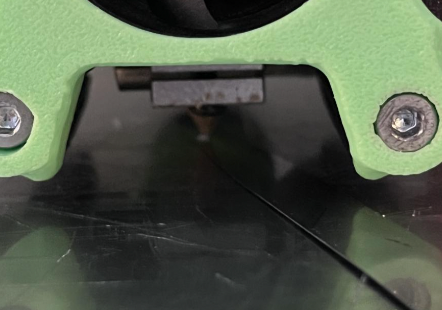 Placement of a tool under a nozzle.